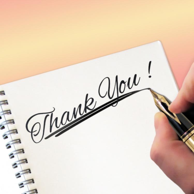 'Thank you' written on a notepad in black ink